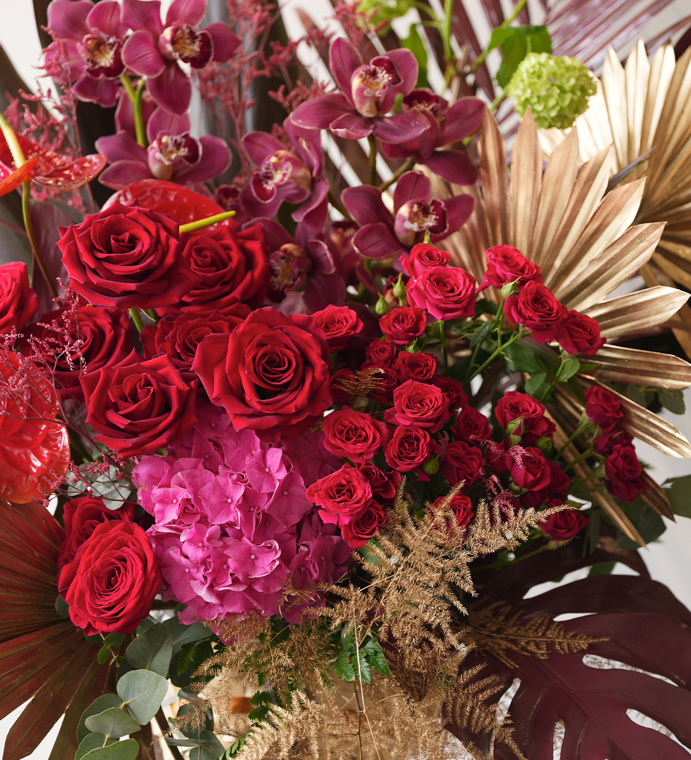 Oakley closeup showing roses, orchids, anthuriums, and tropical foliage