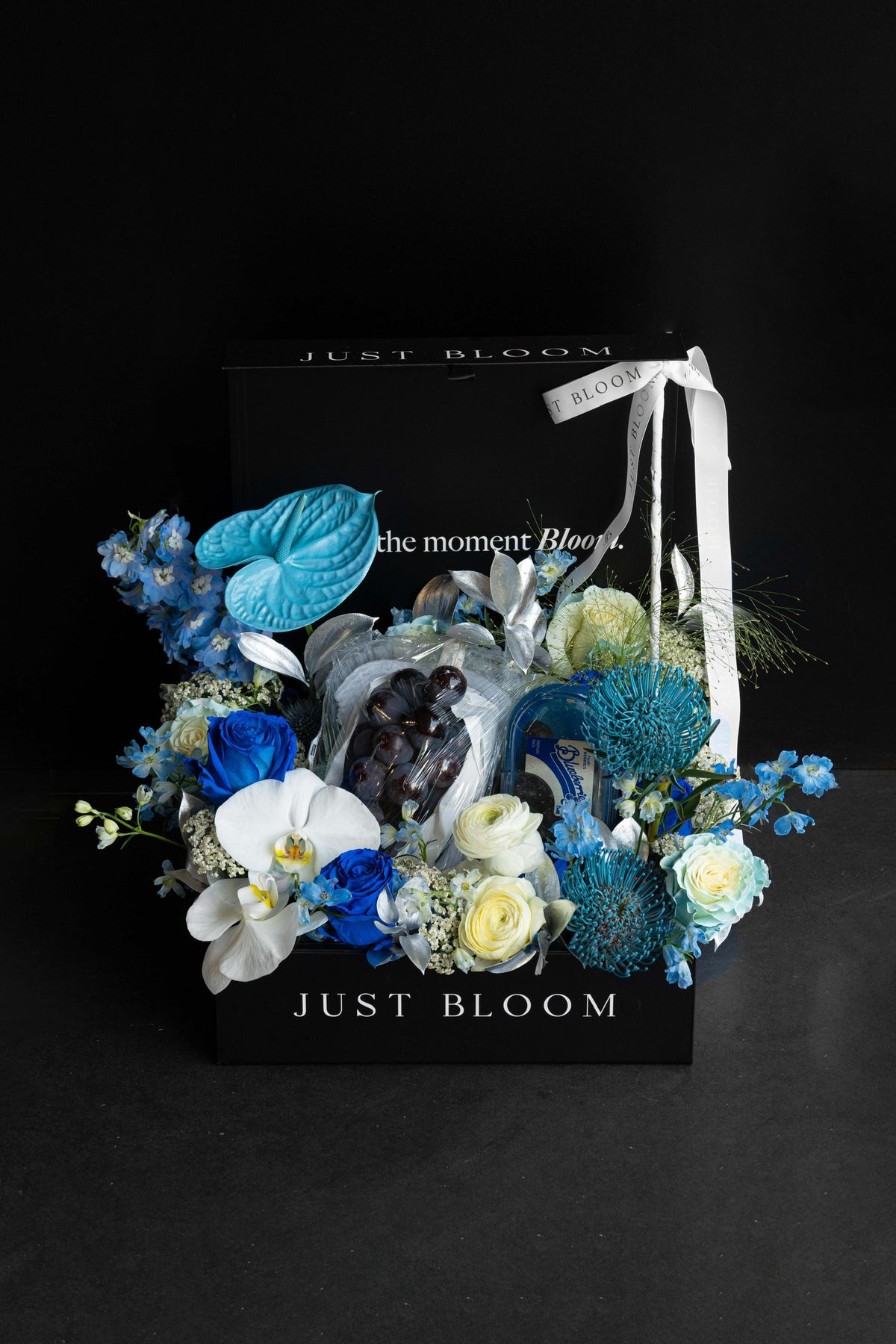 Large all-blue luxury floral hamper with premium Japanese grapes and blueberries in a black Just Bloom box against a dark background — Just Bloom Hong Kong
