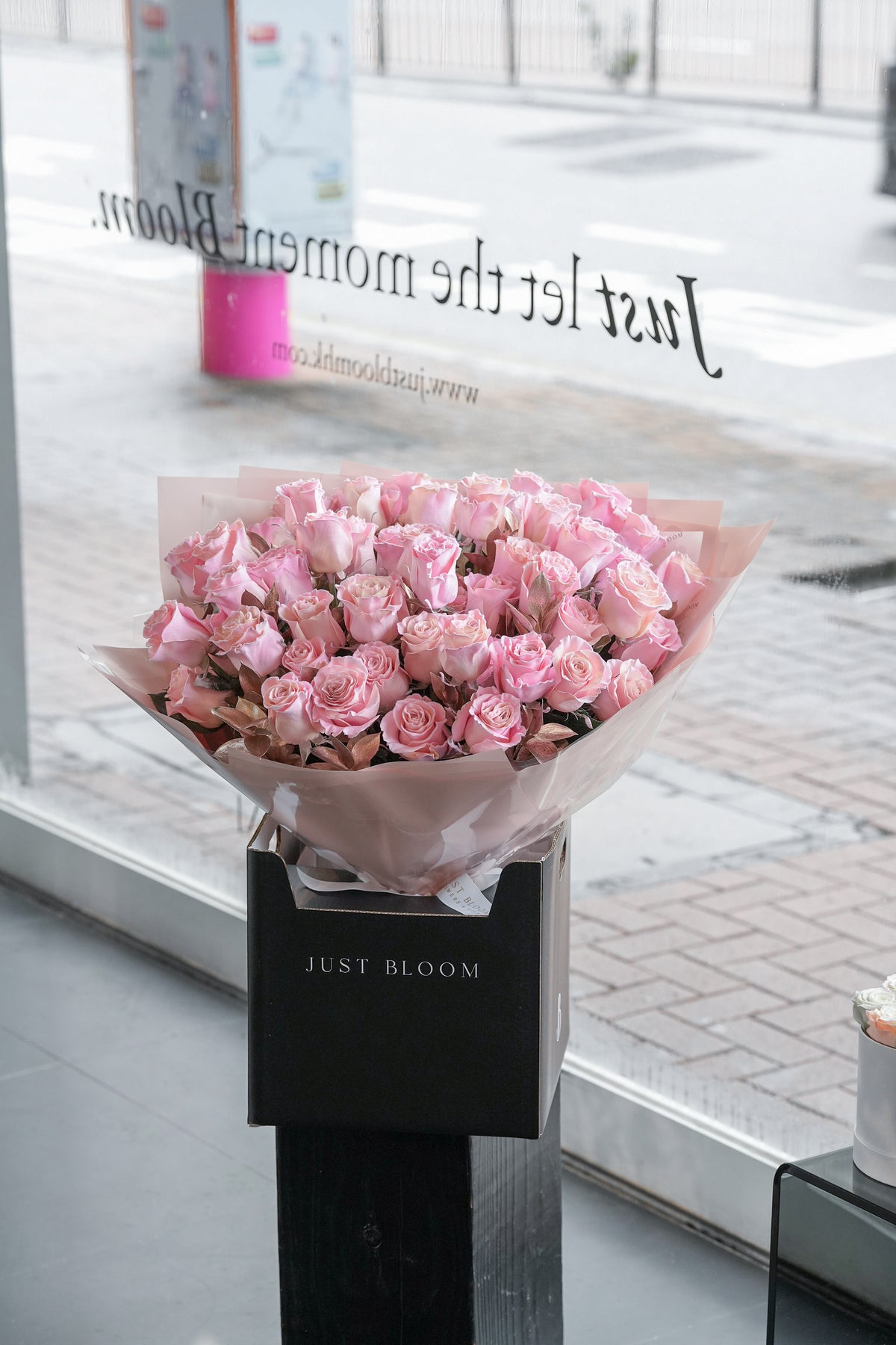 Soft Flush blush rose bouquet displayed outside the Just Bloom flower boutique storefront — Just Bloom Hong Kong
