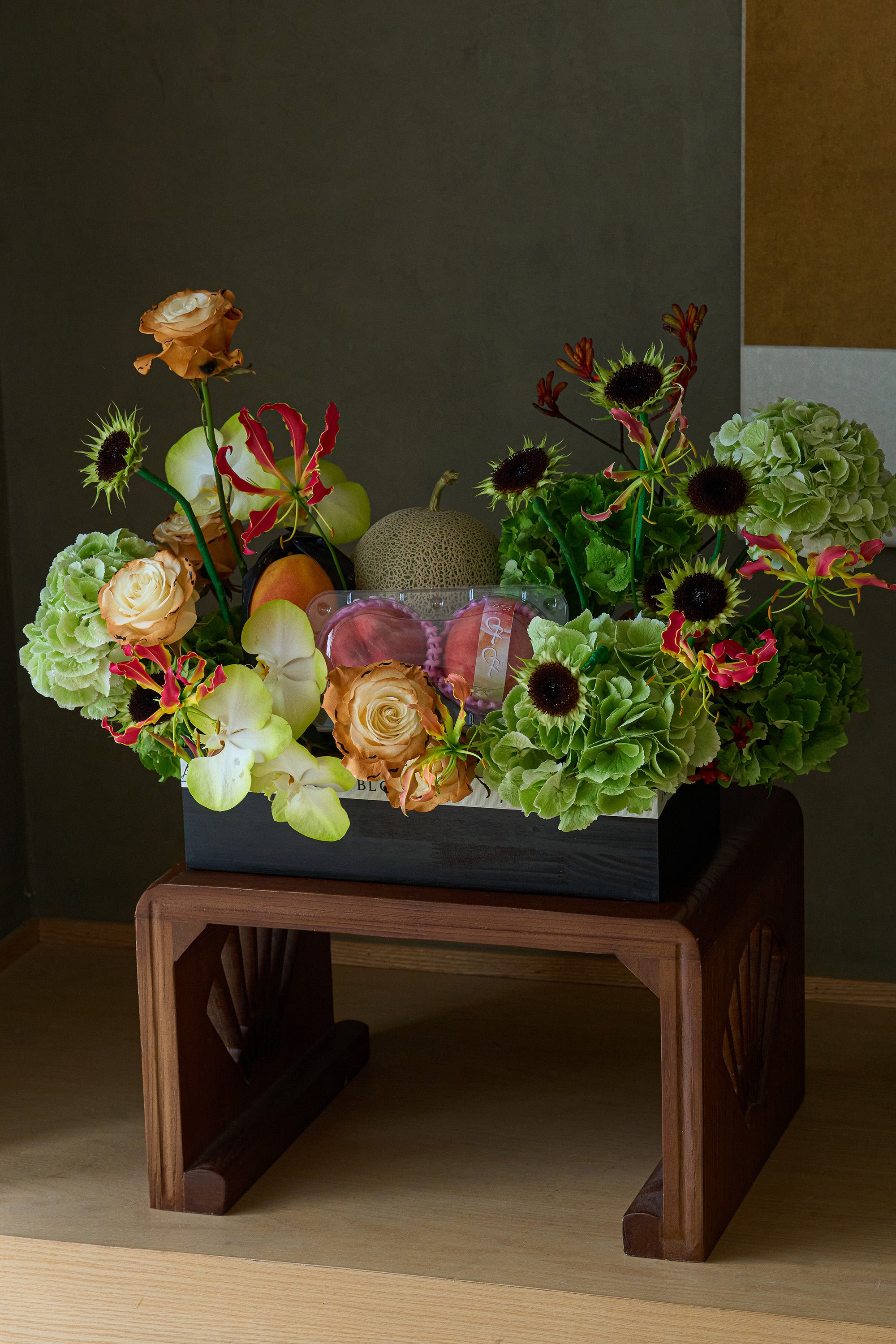 Just Bloom Orchard Ode flower box with green hydrangeas, caramel roses and seasonal fruit on a wooden stand — Just Bloom Hong Kong