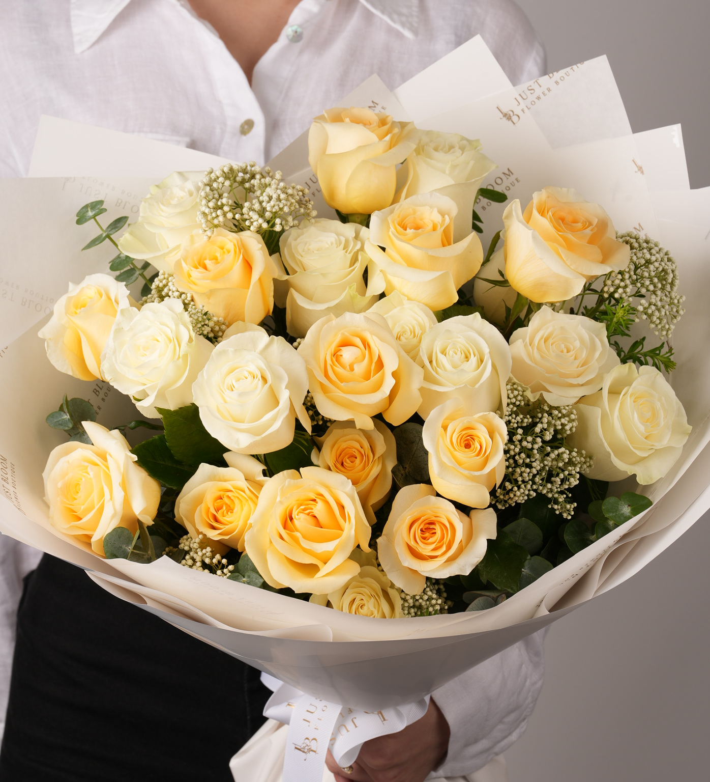 Paityn yellow and cream roses with rice flowers in hand-tied wrapping