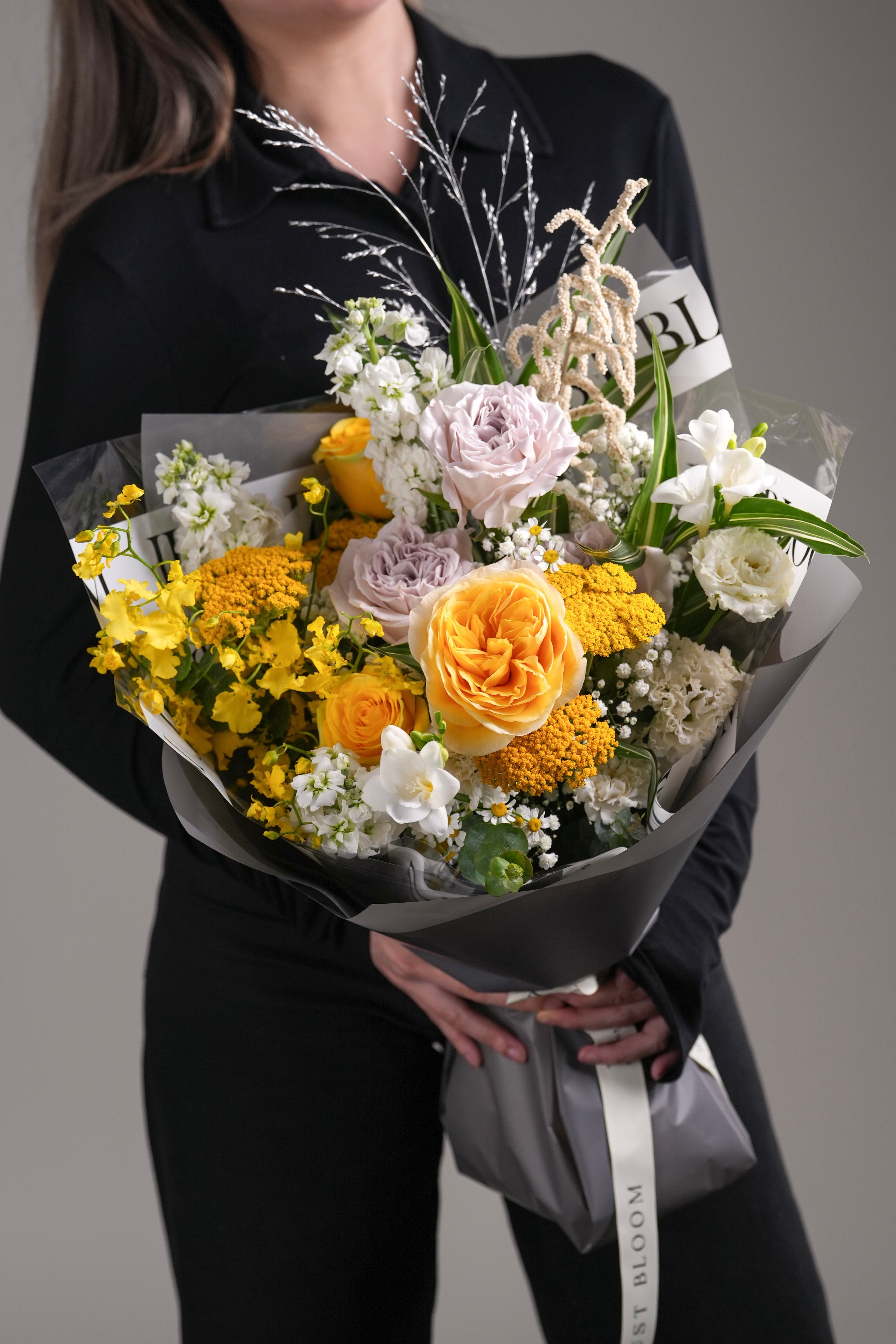 Phoenix bouquet with yellow Ecuador roses, dancing lady orchids, and lavender rose accents