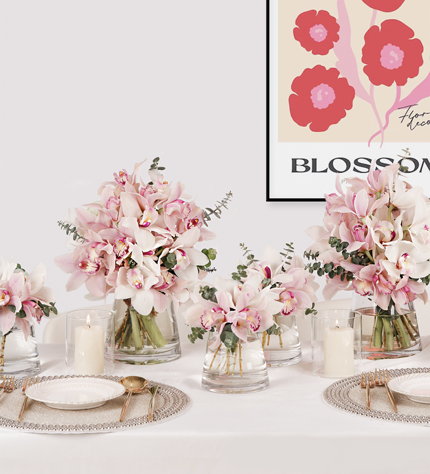 Pink Paradise floral table set with cymbidiums and eucalyptus in blush pink and white