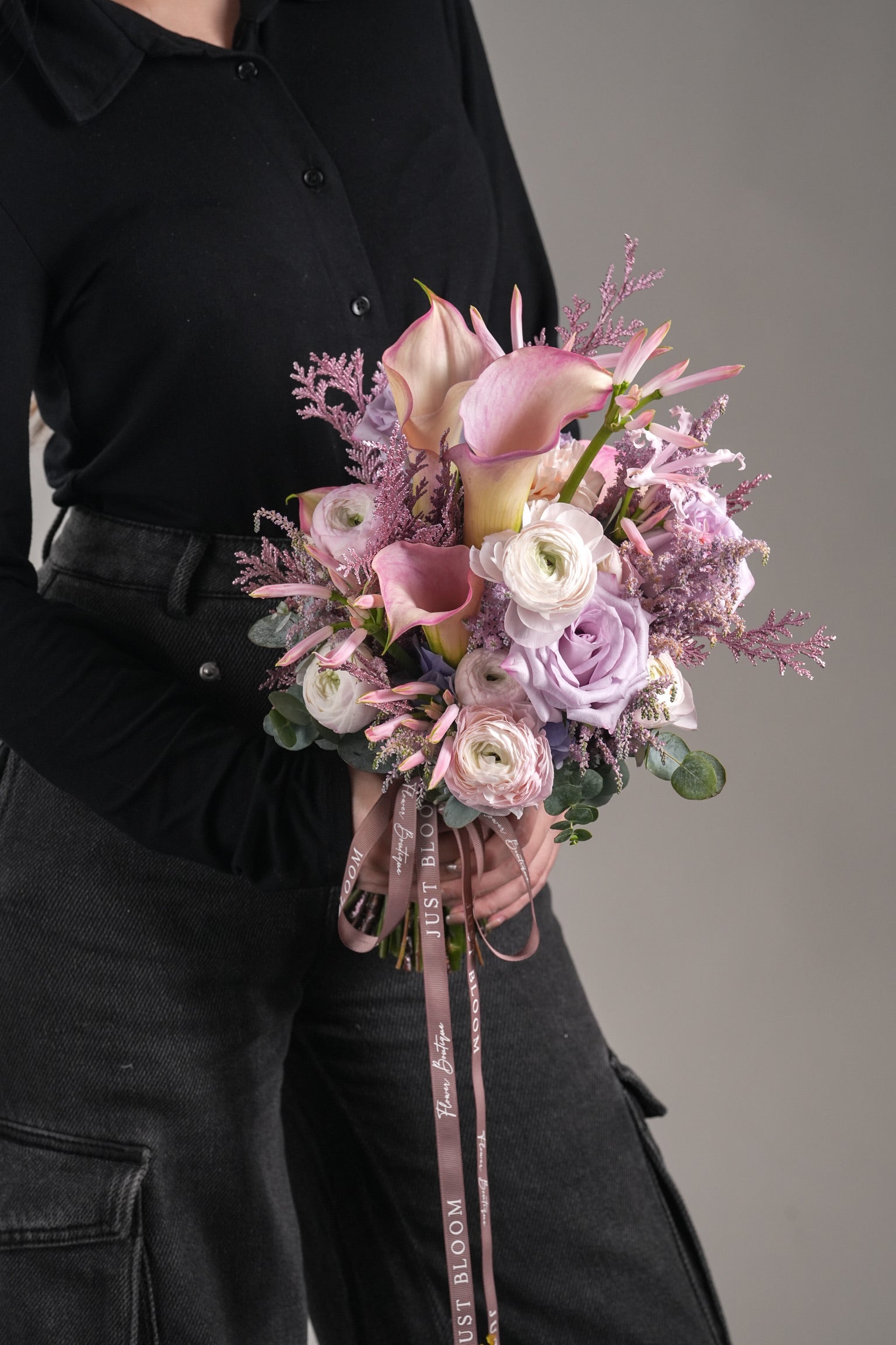 Priscilla pink and purple bouquet held by bride in elegant wedding style