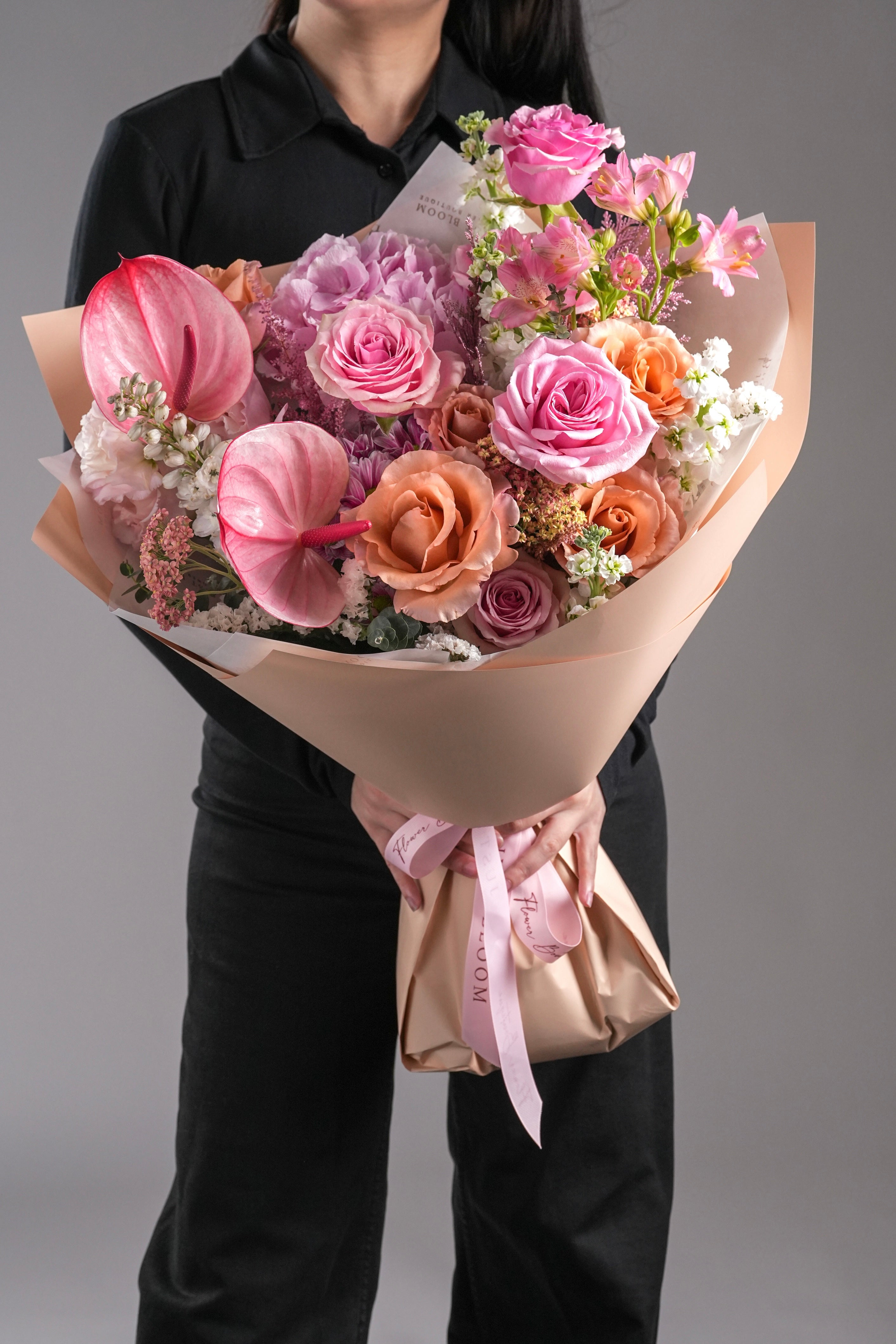 Quinn bouquet with pink hydrangeas, mocha Ecuadorian roses, anthuriums, and stock flowers