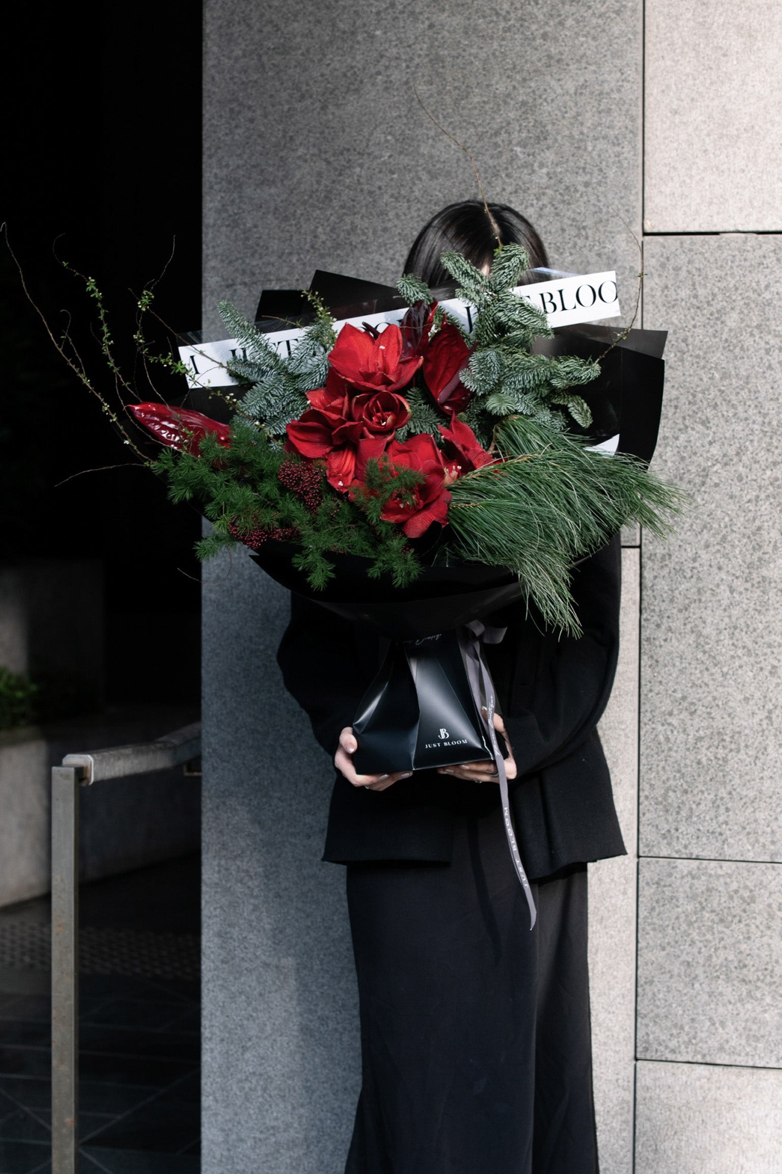 Red Vale bouquet styled with deep red blooms and winter branches