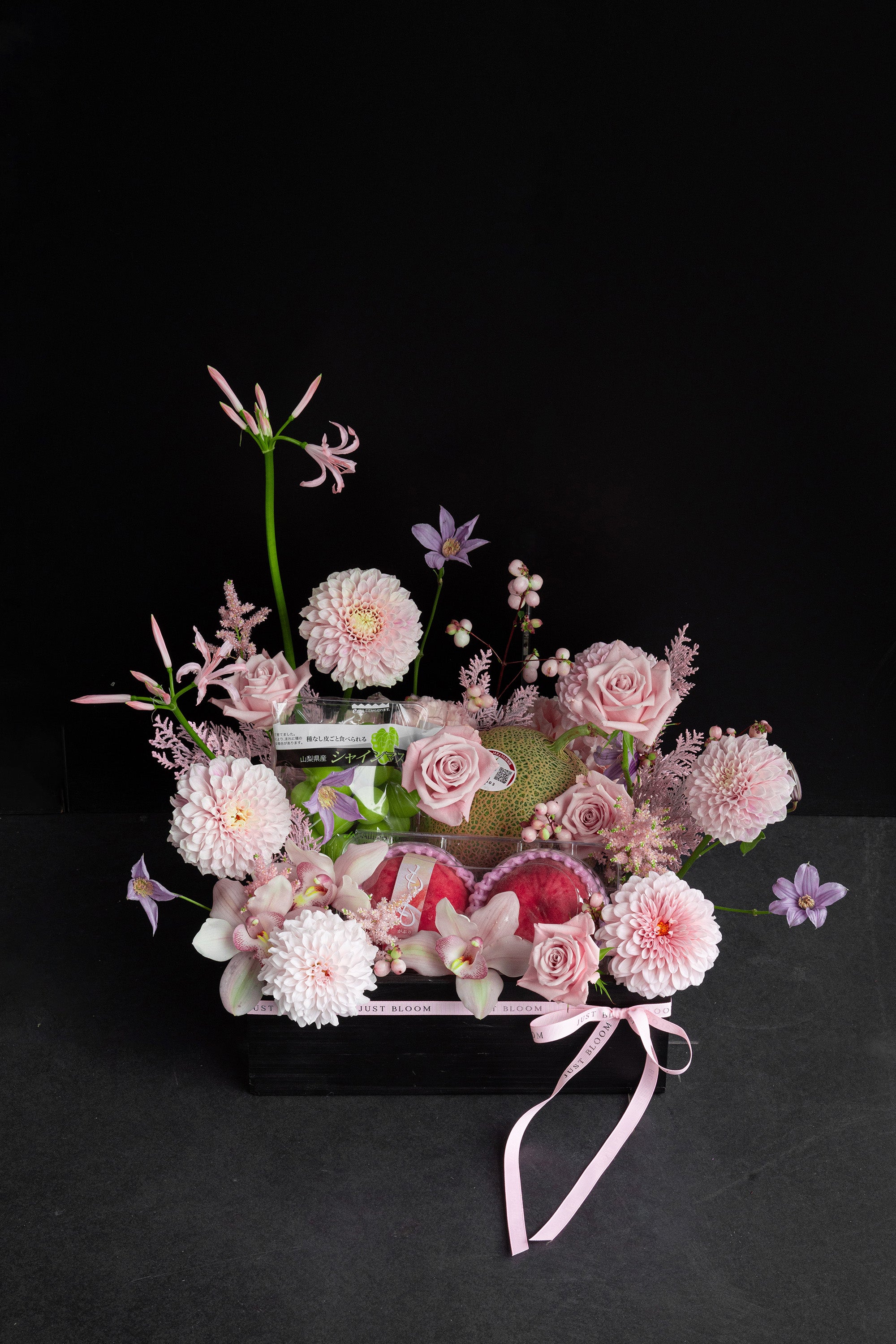 Just Bloom Rosé Harvest flower box with blush pink florals and Japanese seasonal fruit against a black background — Just Bloom Hong Kong