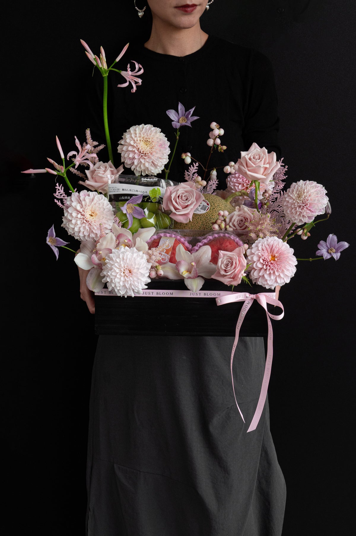 Model holding Just Bloom Rosé Harvest flower box with blush pink florals and Japanese seasonal fruit — Just Bloom Hong Kong