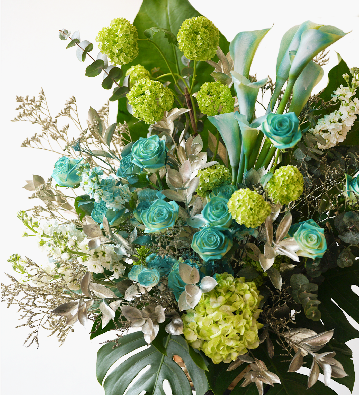 Rowan flower stand close-up with calla lilies, eucalyptus, and green hydrangeas