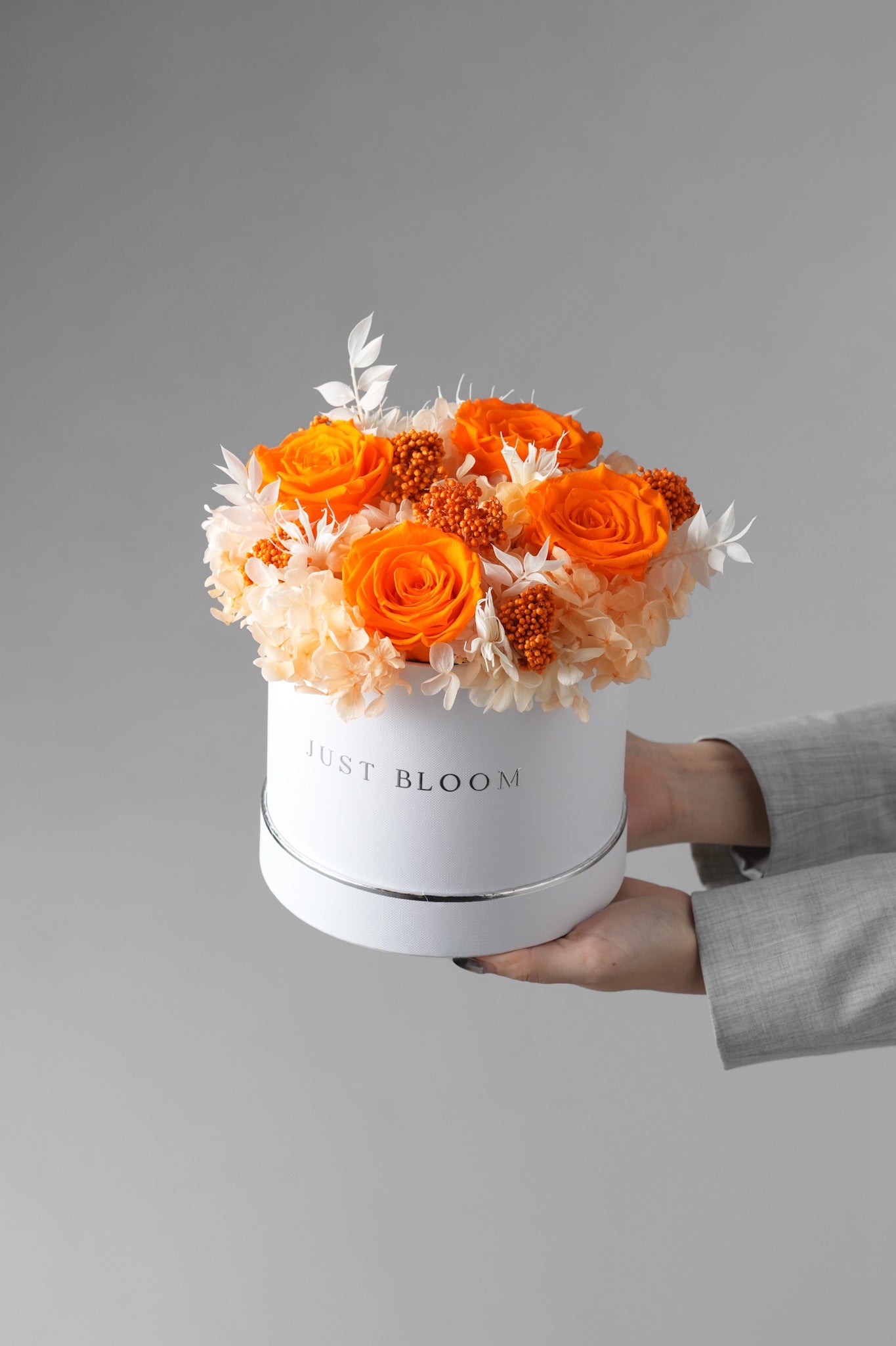Sabina hatbox with preserved orange roses, hydrangeas, and filler berries