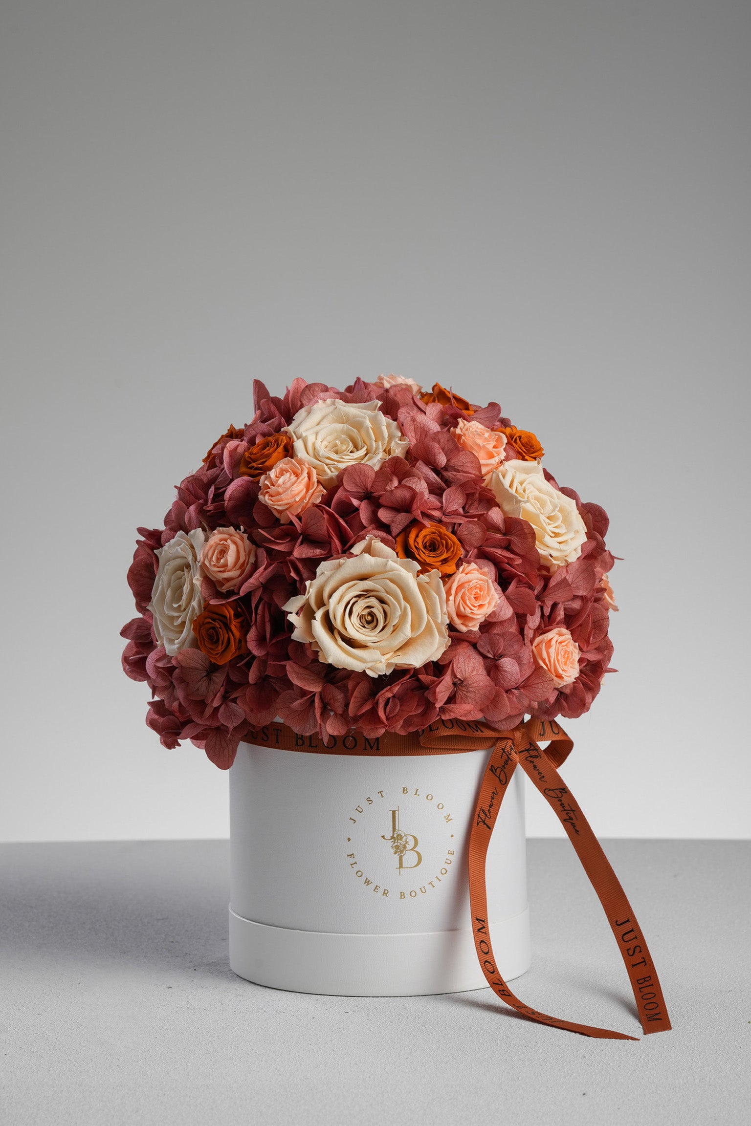 Salem - A preserved flower box in burnt orange and nude tones with preserved roses, hydrangeas, and a crystal balloon topper. Elegant gift by Just Bloom HK.