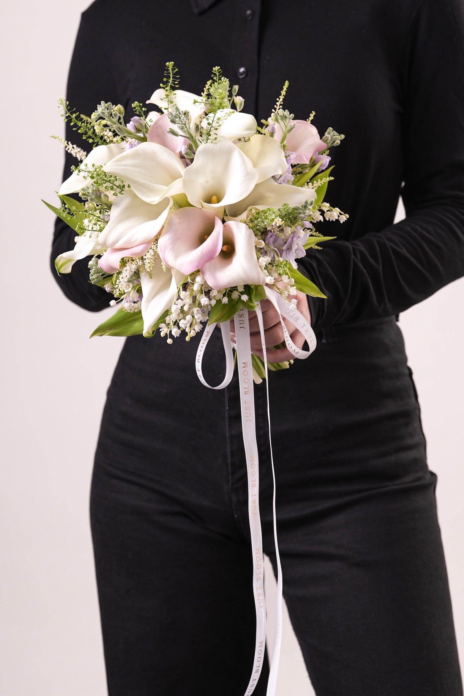 Sasha pastel bridal bouquet featuring white calla lilies, astilbes, and stocks