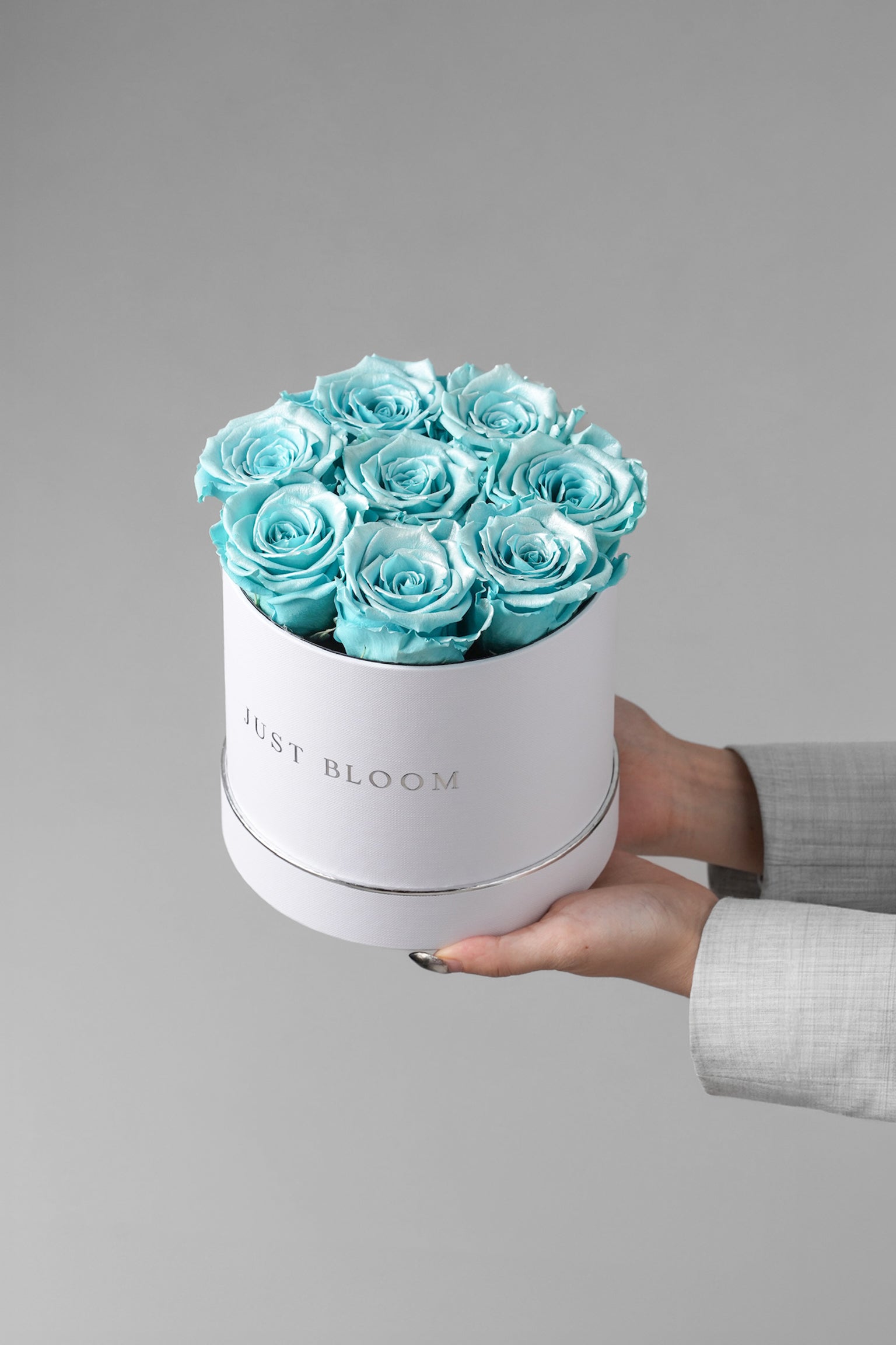 Serenity preserved rose box with aqua blue Ecuadorian roses in a white hatbox
