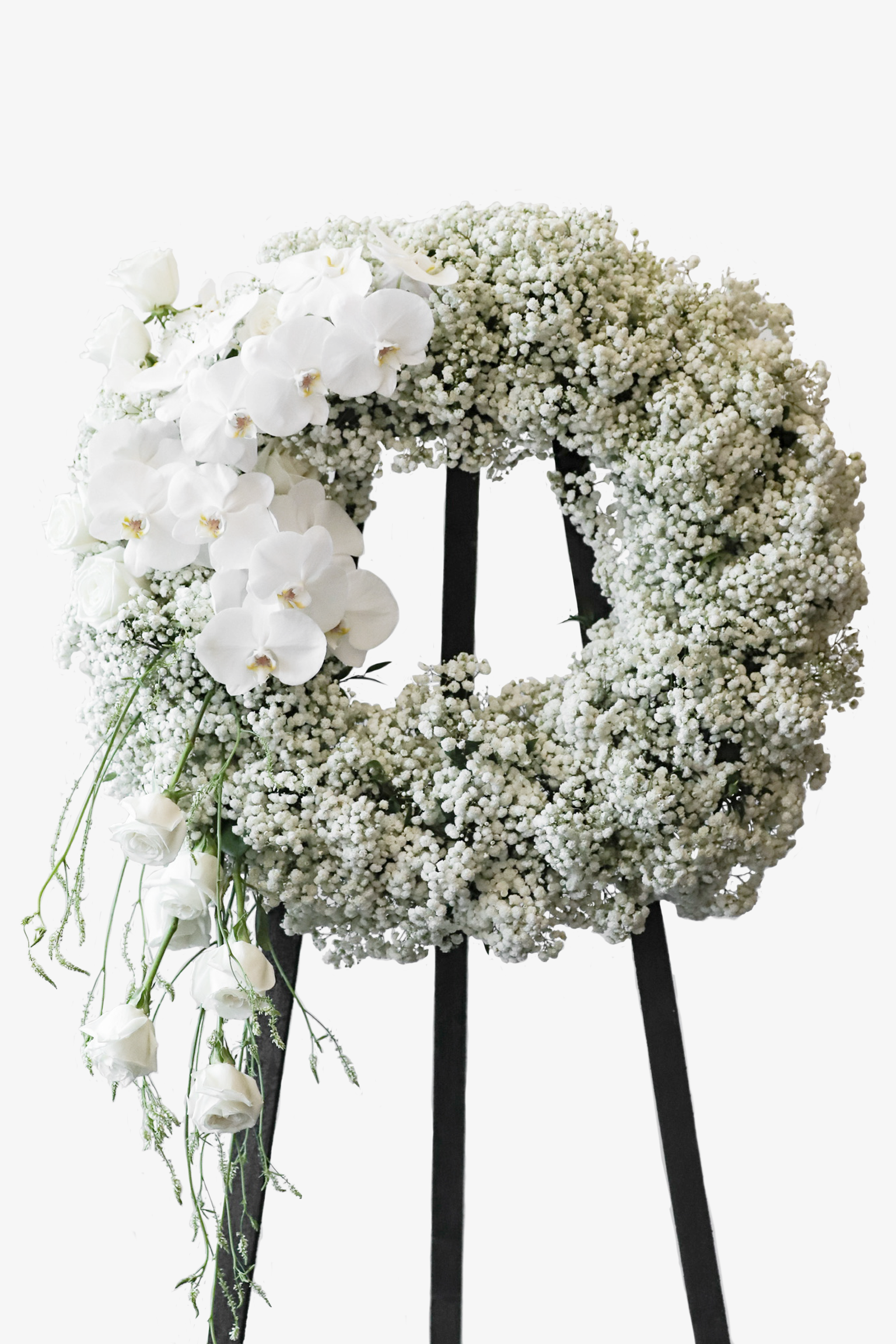 Large all-white condolence wreath with a dense Baby's Breath base, Phalaenopsis Orchids, and a trailing cascade of white Roses on a black standing frame against a white background — Just Bloom Hong Kong