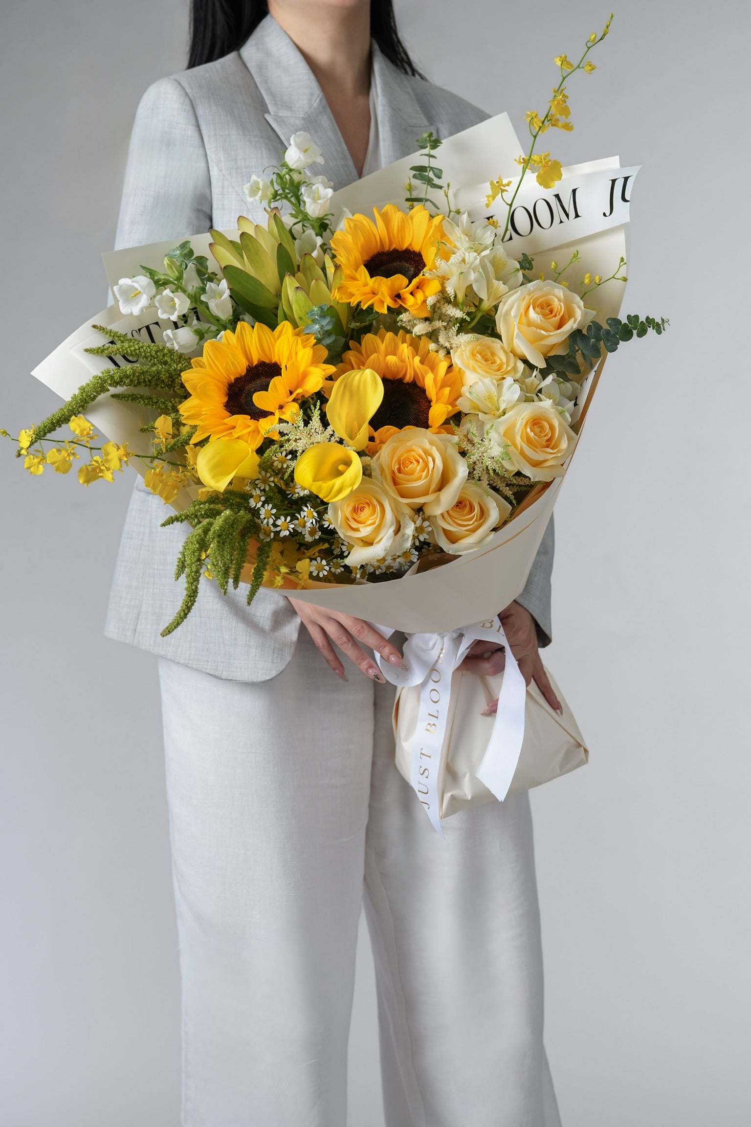 Sunlit Harmony arrangement featuring alstroemerias, proteas, and bellflowers