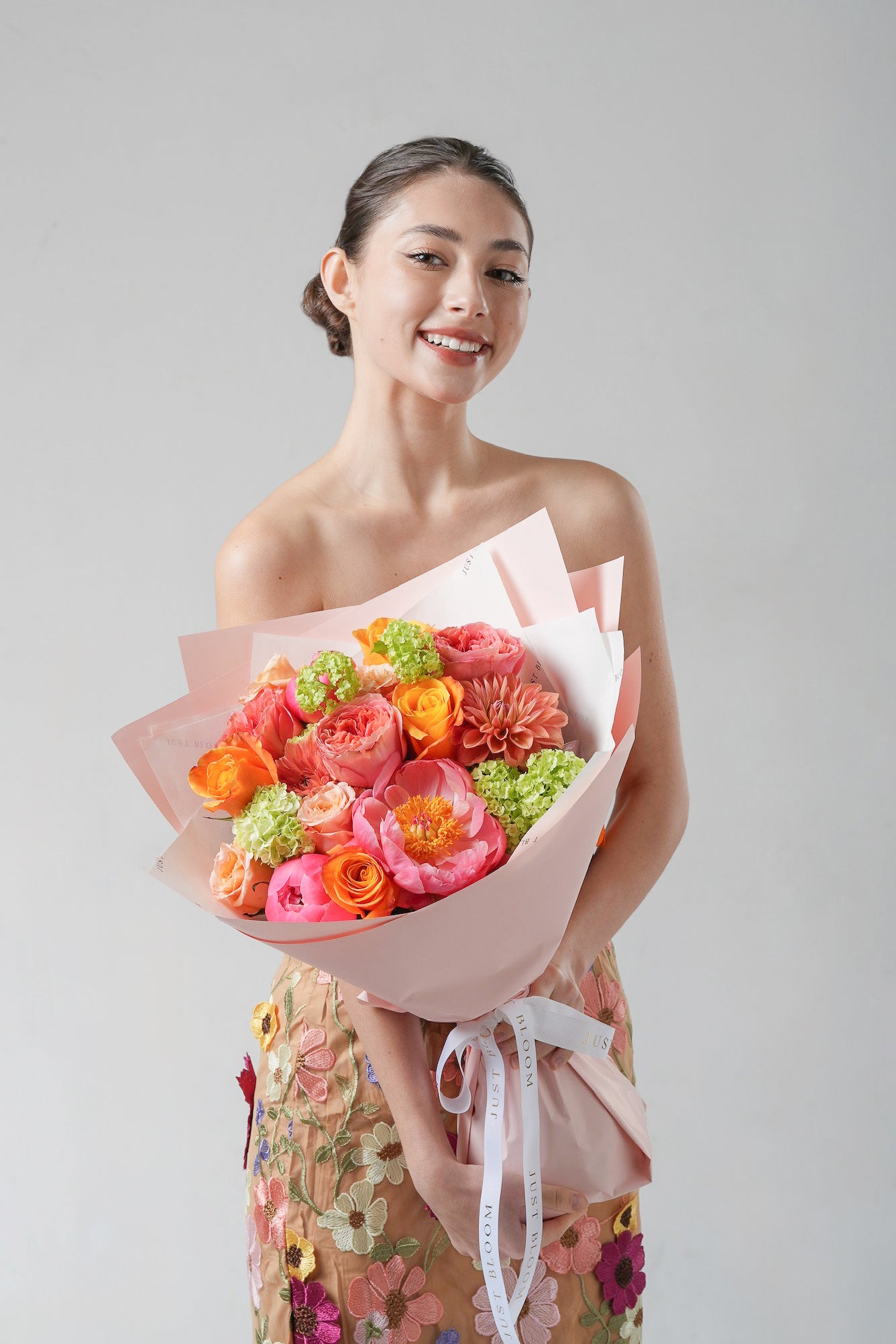 Tender Memory - A cheerful Mother’s Day bouquet featuring coral garden roses, peonies, orange ranunculus, and lime green hydrangeas. A vibrant floral celebration of love from Just Bloom HK.