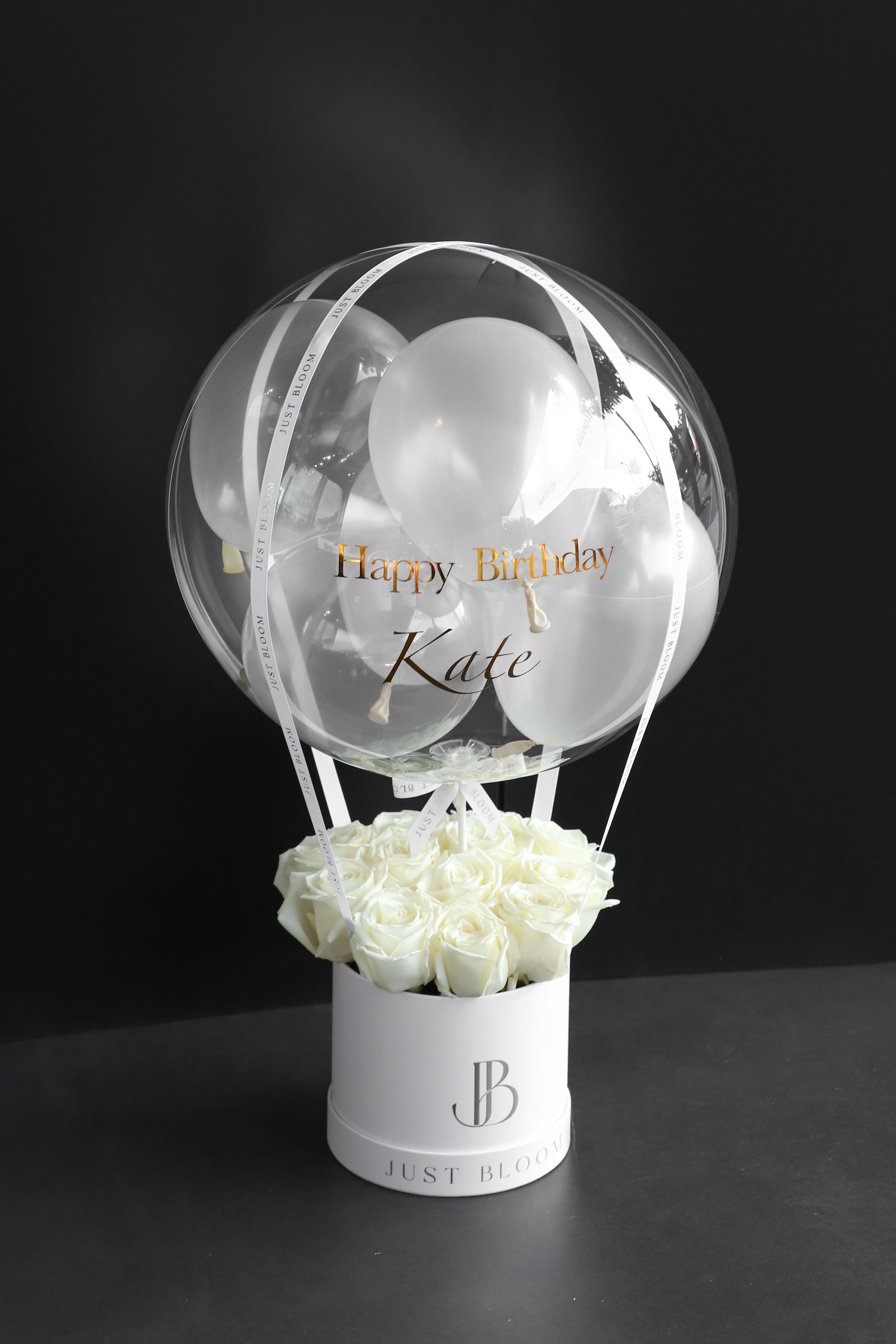 All-white rose balloon flower box with a large crystal balloon containing white and clear balloons in a white Just Bloom round box against a dark background — Just Bloom Hong Kong