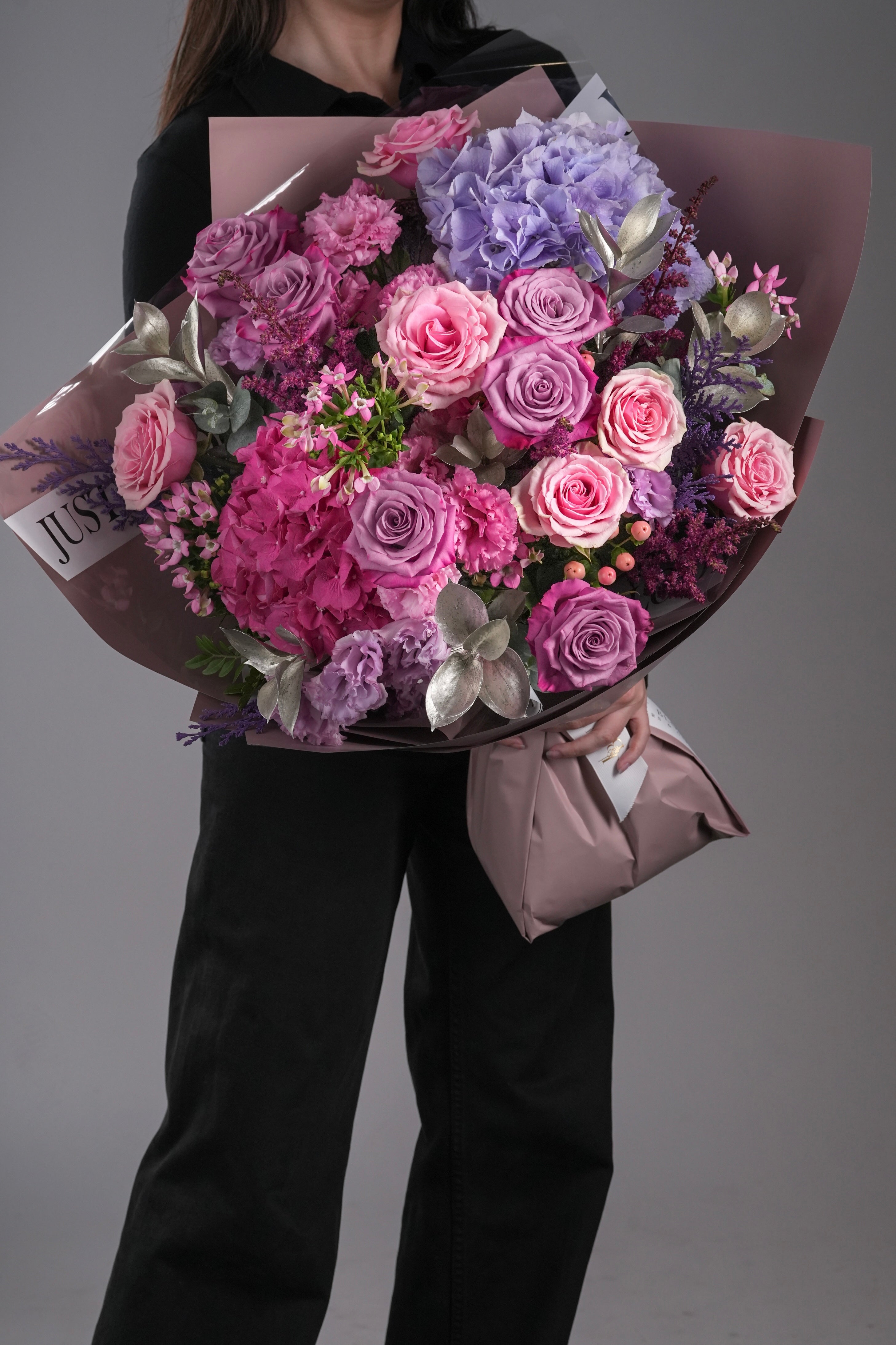 Ruby bouquet with Ecuador roses, purple hydrangeas, eustomas and dyed foliage
