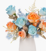 Fresh vase arrangements by Just bloom × Hong Kong Florist, featuring Ecuadorian dyed blue and orange roses symbolizing significant meanings, showcased in a sleek white vase, with vibrant hues.