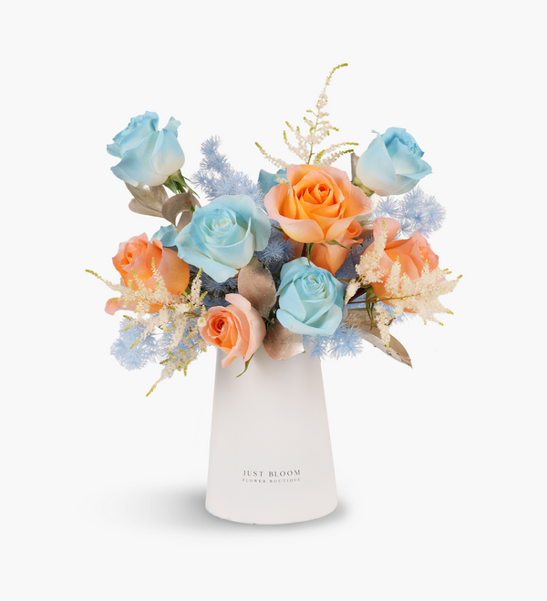 Fresh vase arrangements by Just bloom × Hong Kong Florist, featuring Ecuadorian dyed blue and orange roses symbolizing significant meanings, showcased in a sleek white vase, with vibrant hues.
