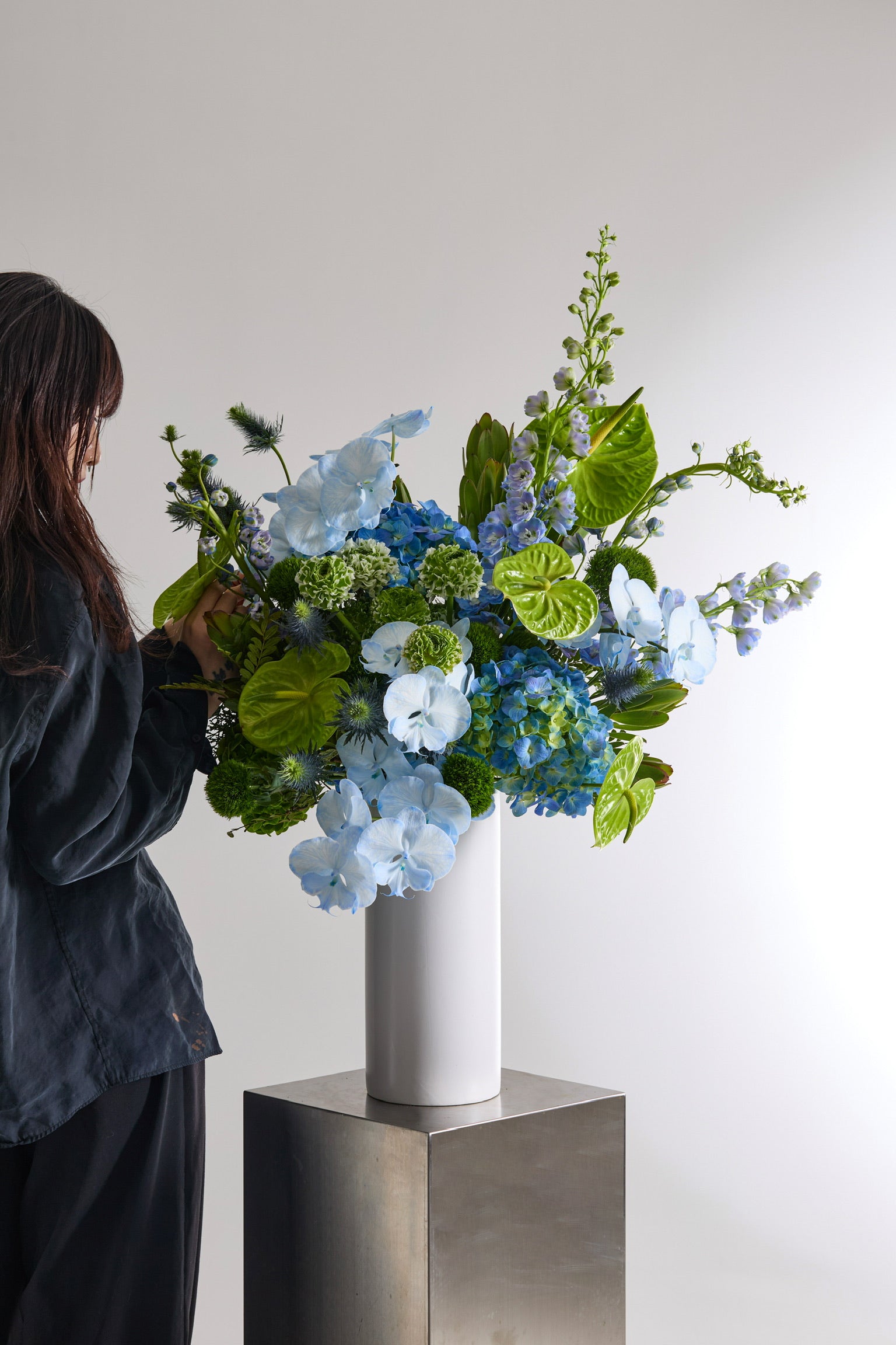 Verdant Blue Vase with Hydrangeas, Anthuriums, Delphiniums, Ranunculuses, Phalaenopsis Orchids, Eryngiums, and Green Trick Dianthuses by Just Bloom Hong Kong