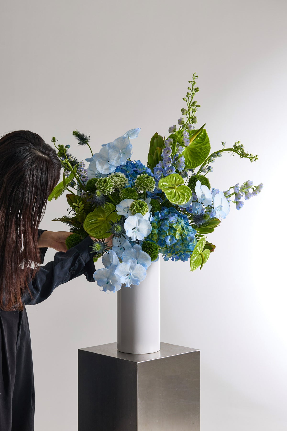 Verdant Blue Vase with Hydrangeas, Anthuriums, Delphiniums, Ranunculuses, Phalaenopsis Orchids, Eryngiums, and Green Trick Dianthuses by Just Bloom Hong Kong