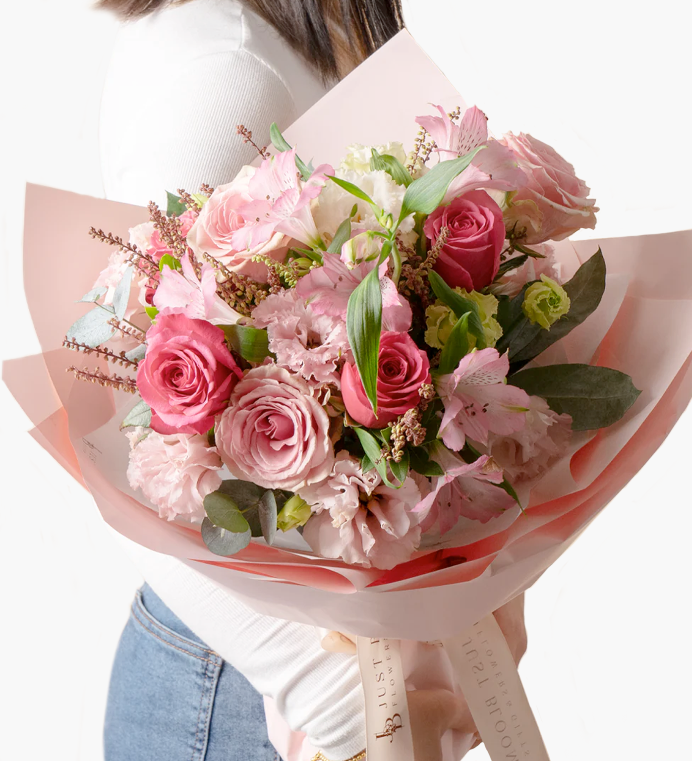 Model holding Elena pink bouquet with visible flower textures and soft wrapping