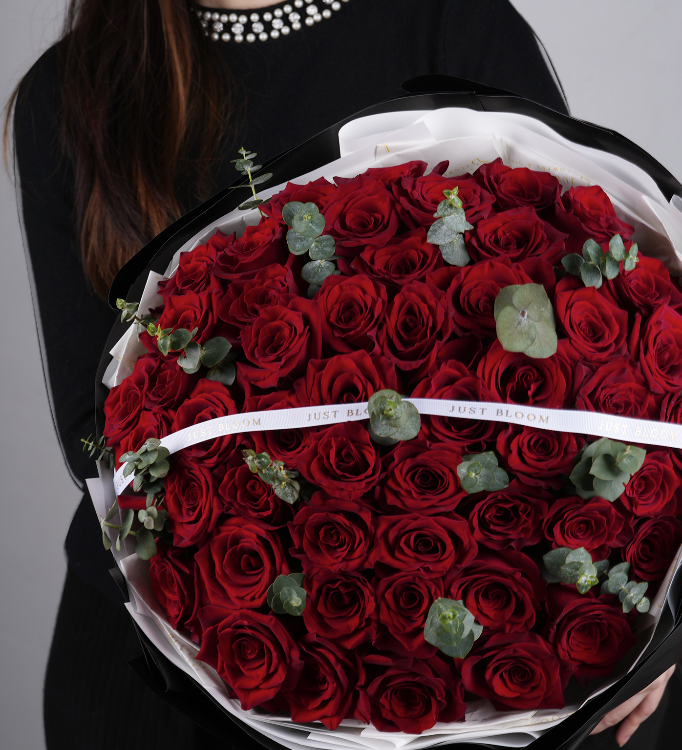 Just Bloom Hong Kong luxury red rose bouquet held by model in black