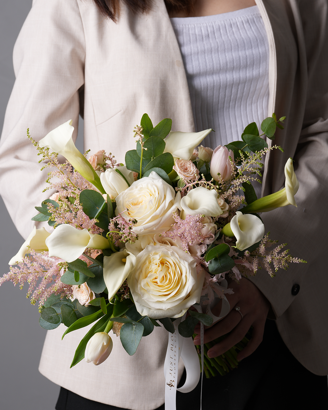 Maria wedding bouquet featuring premium roses, calla lilies, tulips, astilbes, and eucalyptus – close-up
