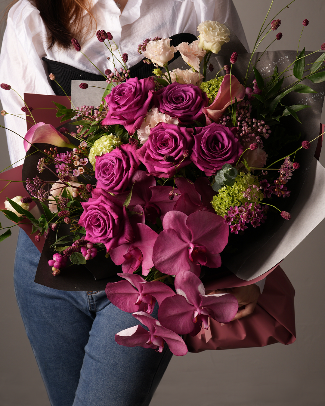 lose-up of Miranda bouquet featuring blue tulips and Clematis with white flowers