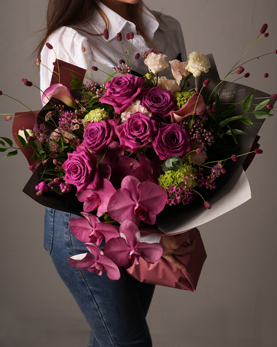 Miranda bouquet with blue tulips, Clematis, and white floral fillers
