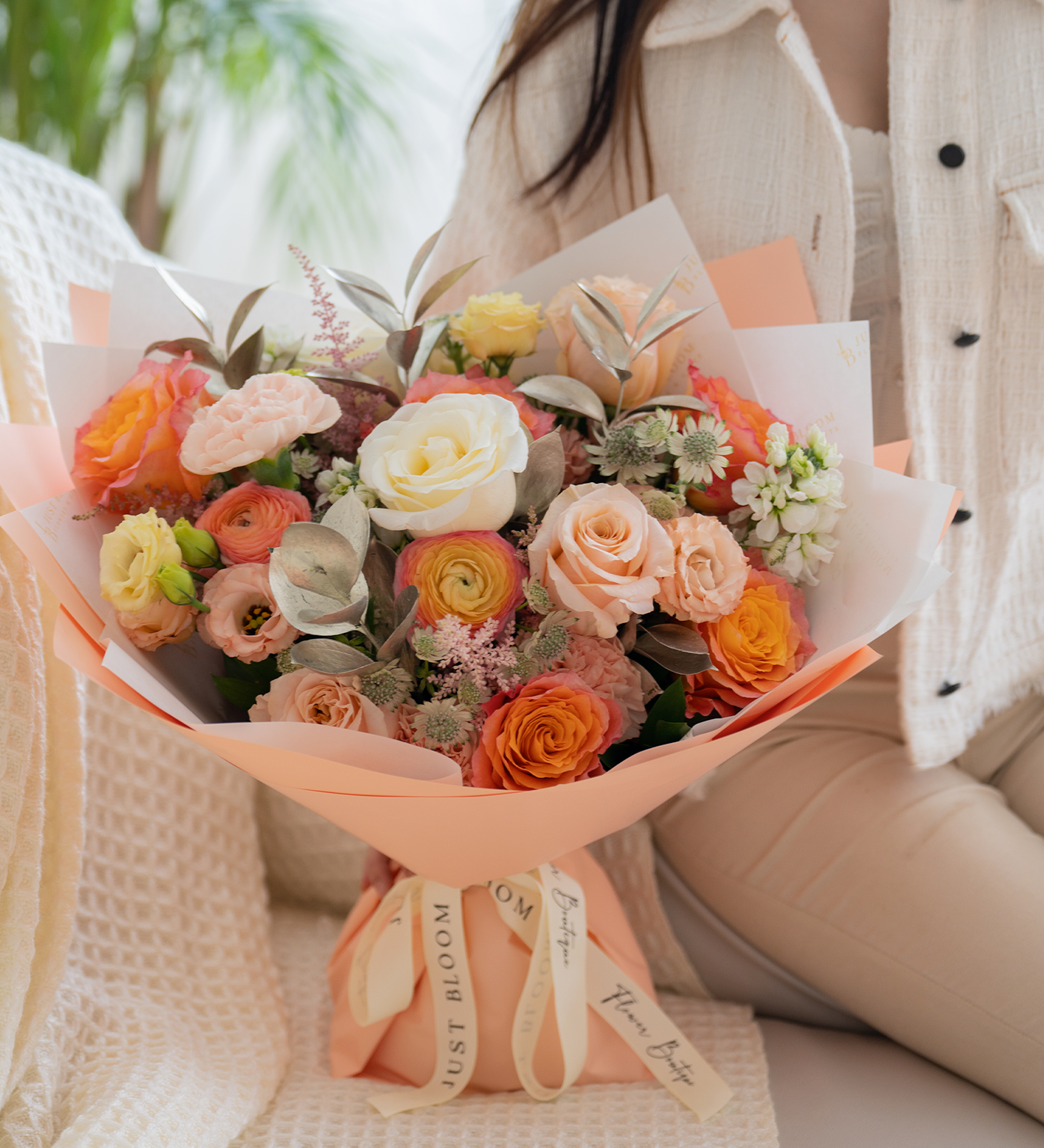Palmer peach and cream bouquet held by model, showing full arrangement
