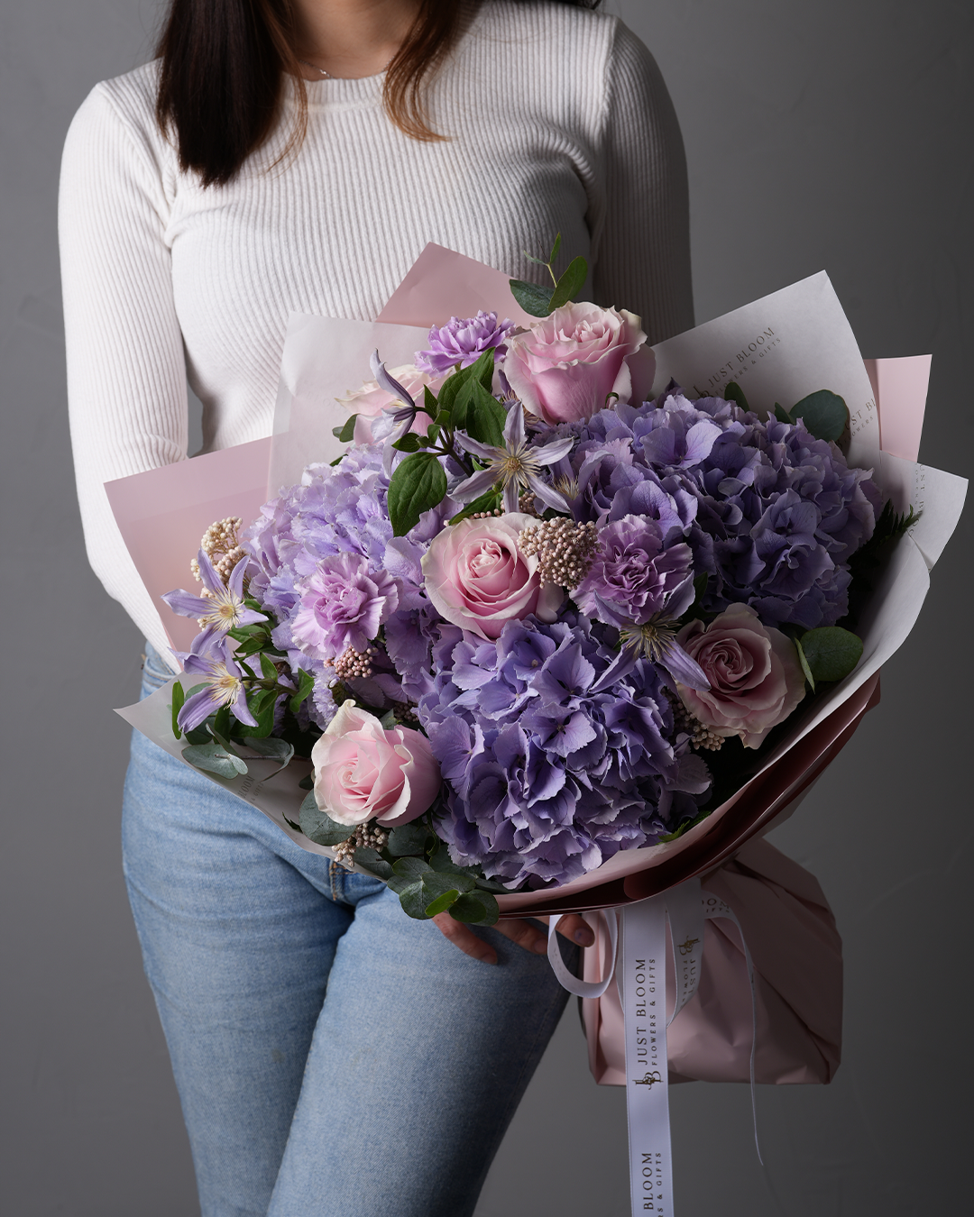 Peyton bouquet with purple hydrangeas, soft pink roses, clematis, and rice flowers