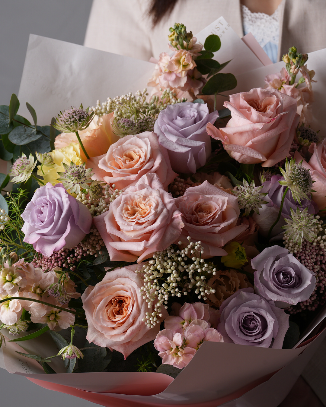 Raelynn floral arrangement featuring pastel roses and eucalyptus with romantic fillers