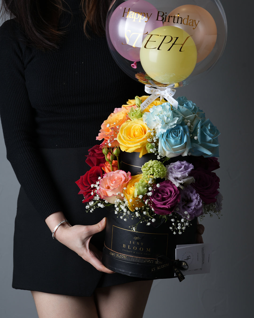 Rainbow Cake flower box with two tiers of colourful roses, eustomas, and baby’s breath in rainbow colours