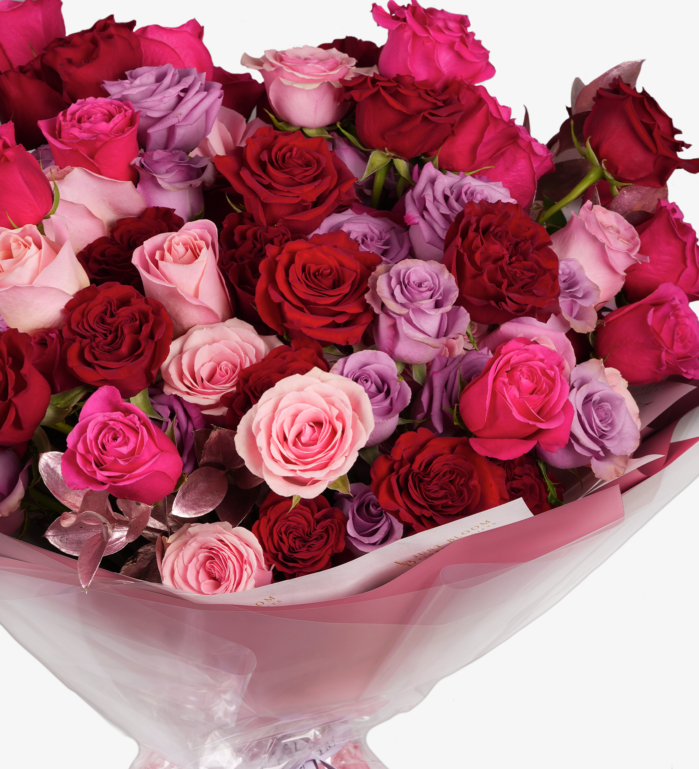 Sawyer bouquet close-up showing red roses, pink roses, and lilac roses in lush arrangement