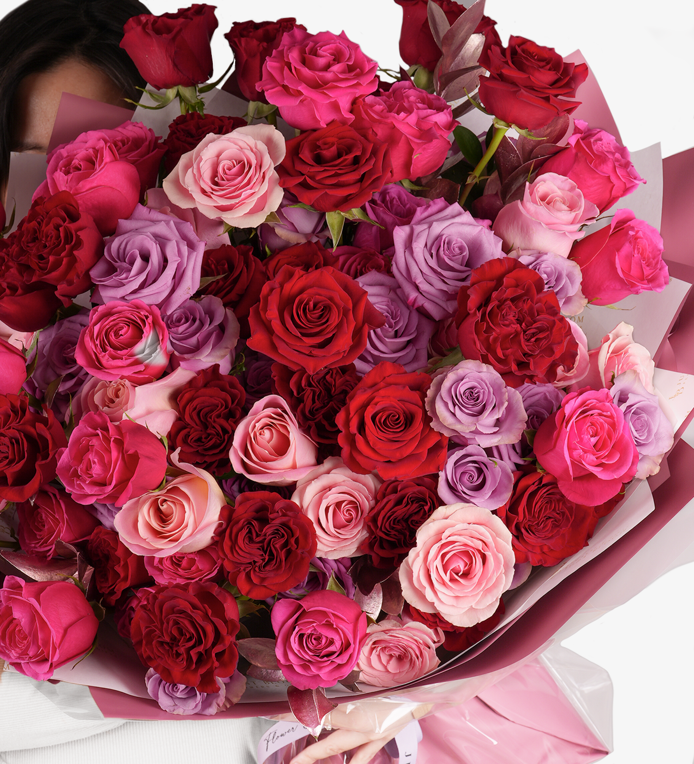 Sawyer bouquet detailed view of red, pink, and lilac roses highlighting romantic textures