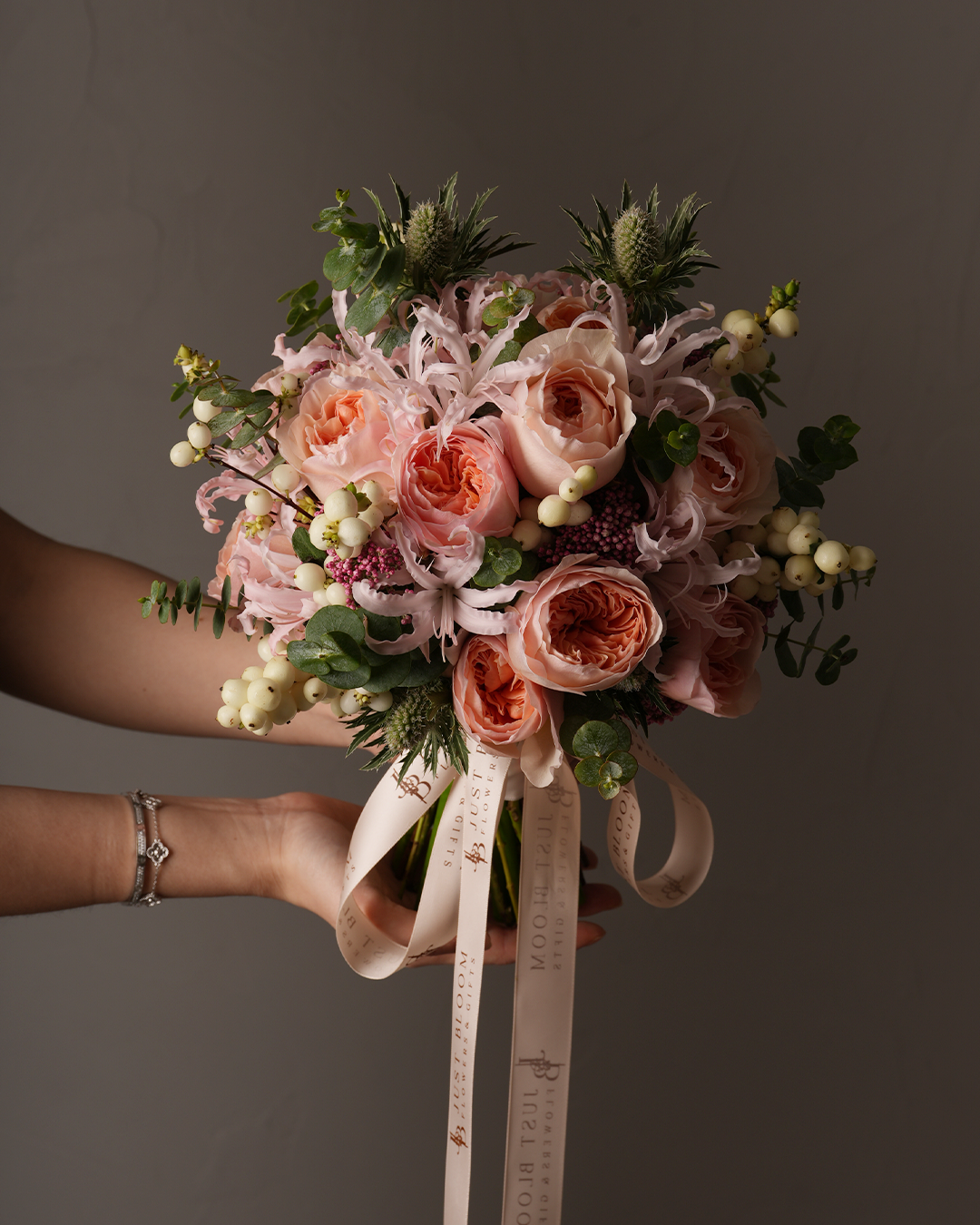 Sloane bridal bouquet with peach Juliet garden roses and snowberries